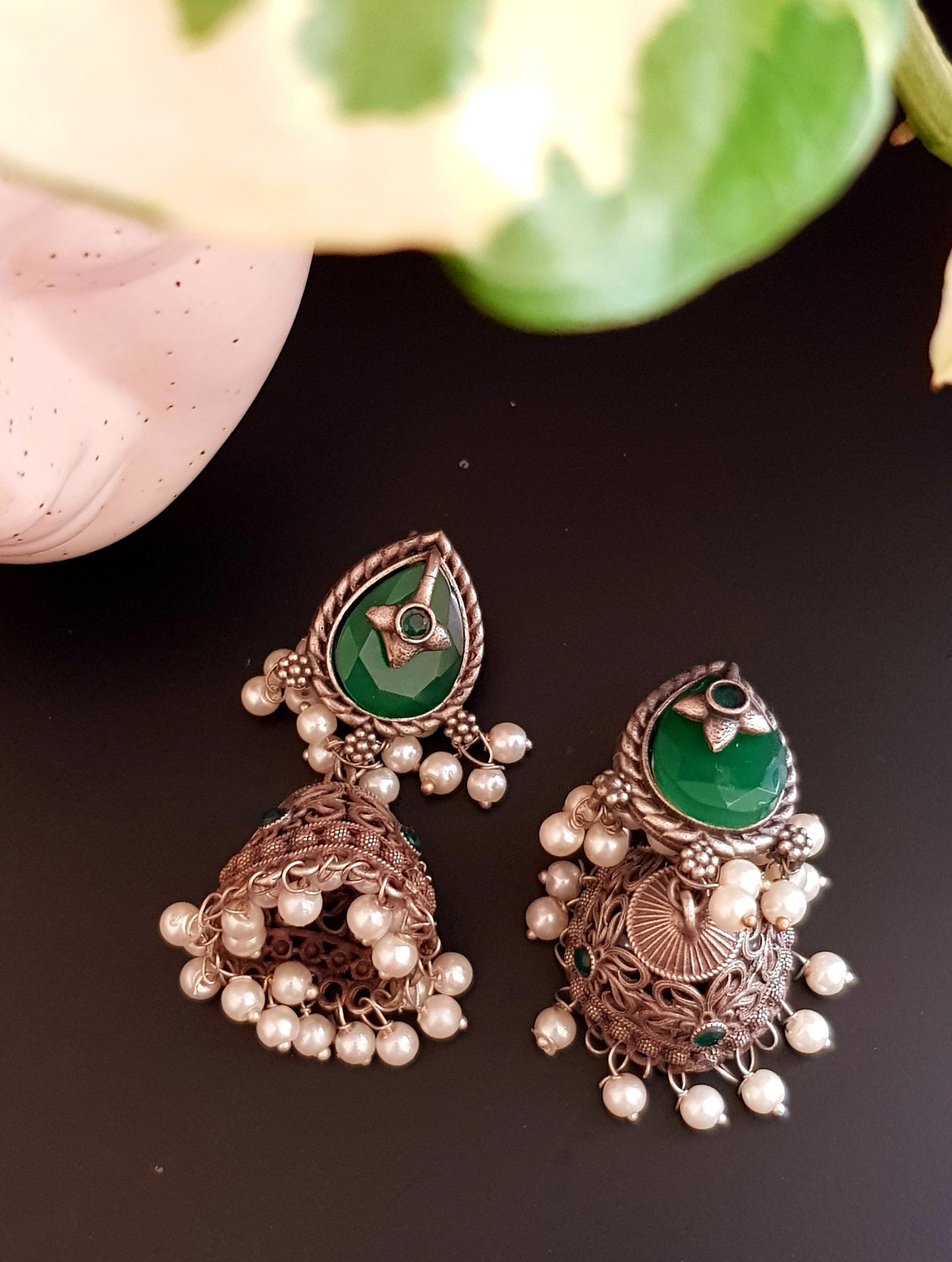 Silver finish jhumka (earrings), jaali designed dome under studs with green/white marble tearshaped stone