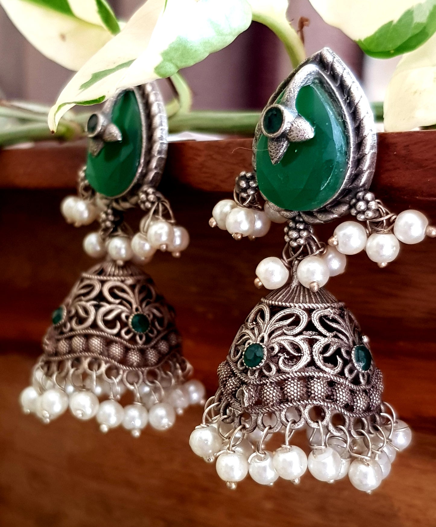 Silver finish jhumka (earrings), jaali designed dome under studs with green/white marble tearshaped stone