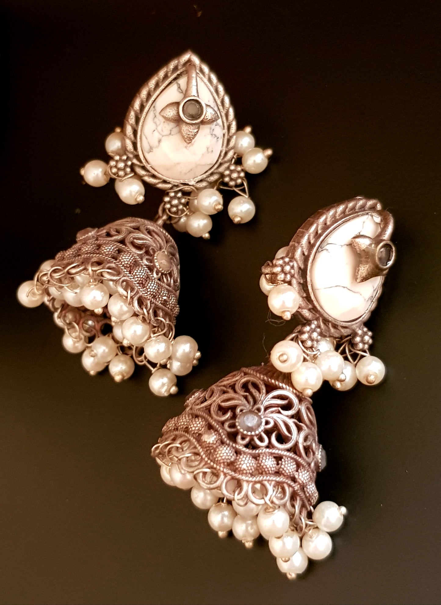 Silver finish jhumka (earrings), jaali designed dome under studs with green/white marble tearshaped stone