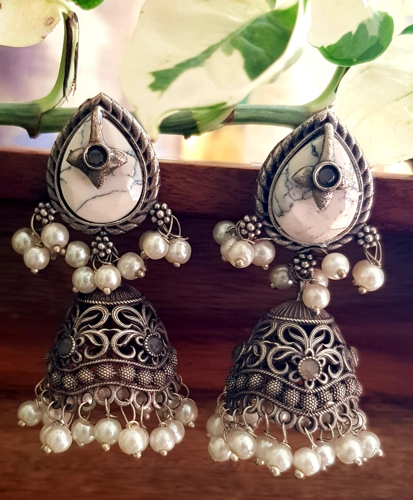 Silver finish jhumka (earrings), jaali designed dome under studs with green/white marble tearshaped stone