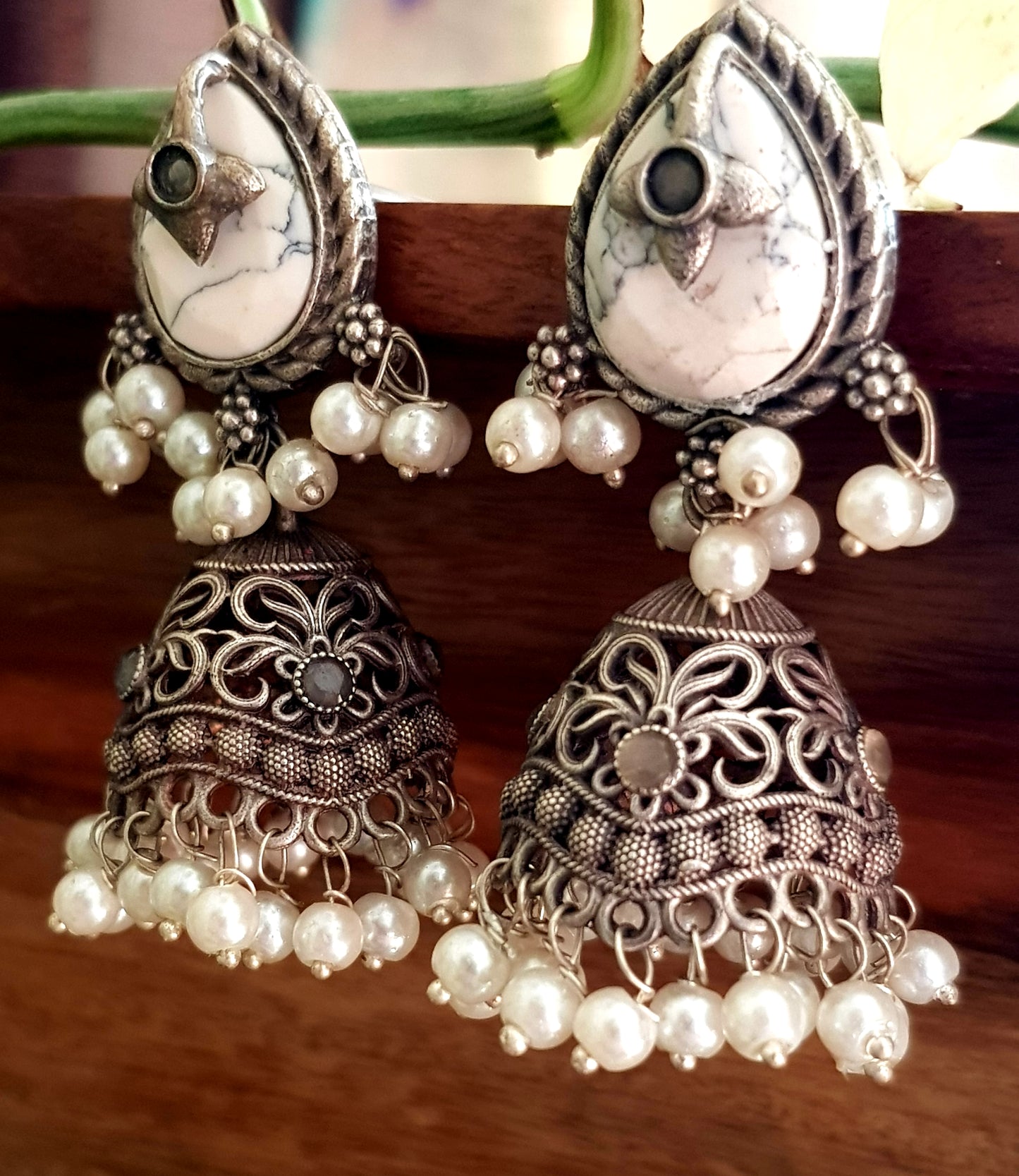 Silver finish jhumka (earrings), jaali designed dome under studs with green/white marble tearshaped stone