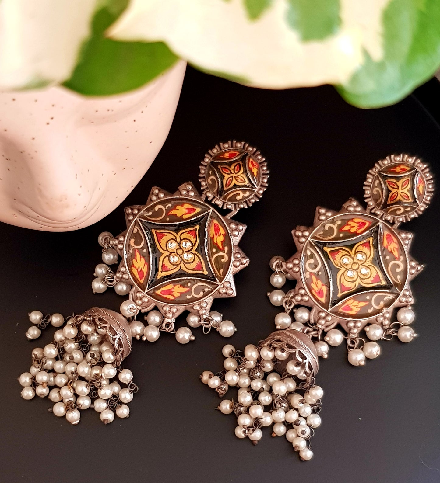 Silver finish long jhumka (earrings) with handpainted sun shaped pieces and pearl trailings