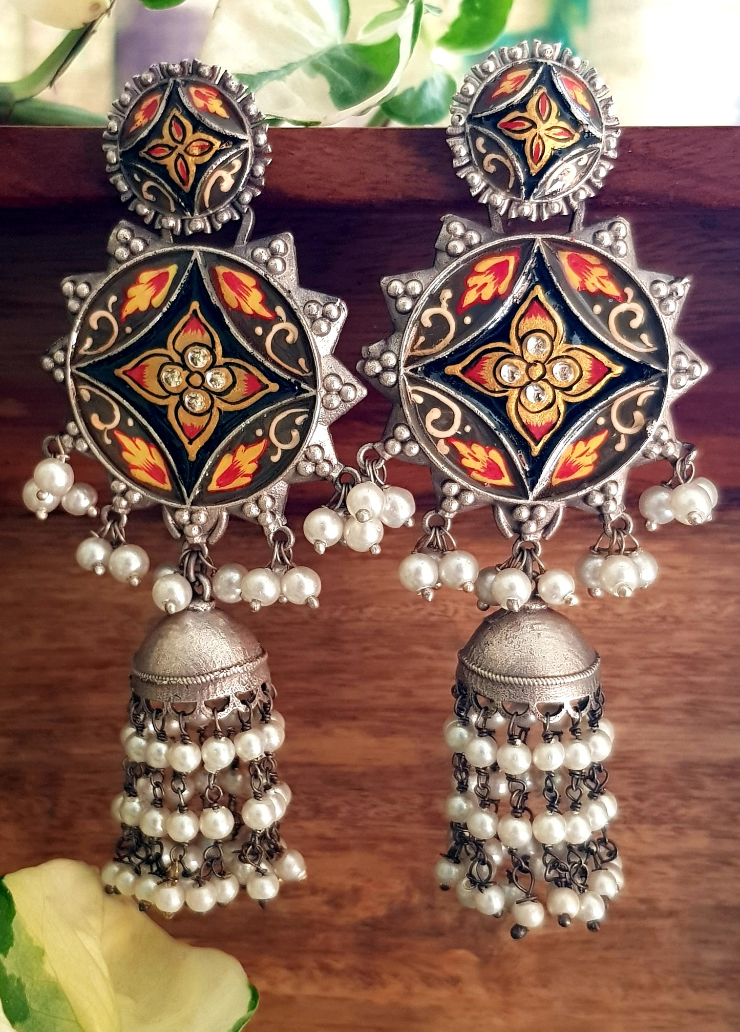 Silver finish long jhumka (earrings) with handpainted sun shaped pieces and pearl trailings