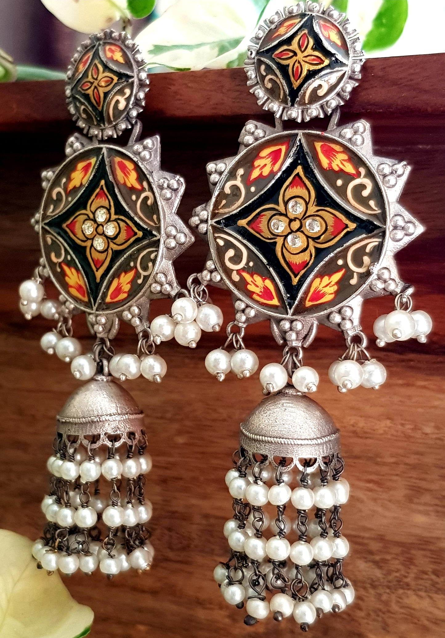 Silver finish long jhumka (earrings) with handpainted sun shaped pieces and pearl trailings