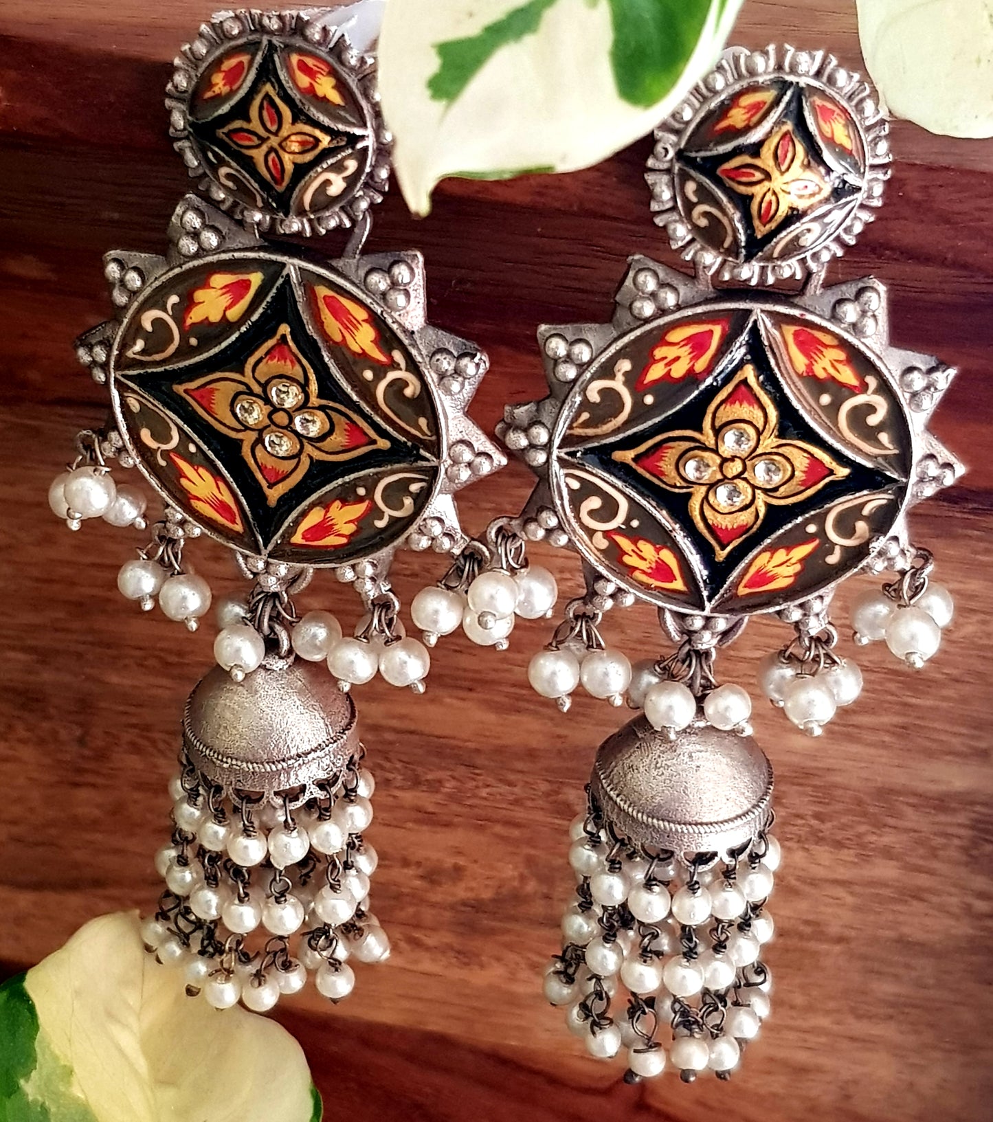 Silver finish long jhumka (earrings) with handpainted sun shaped pieces and pearl trailings