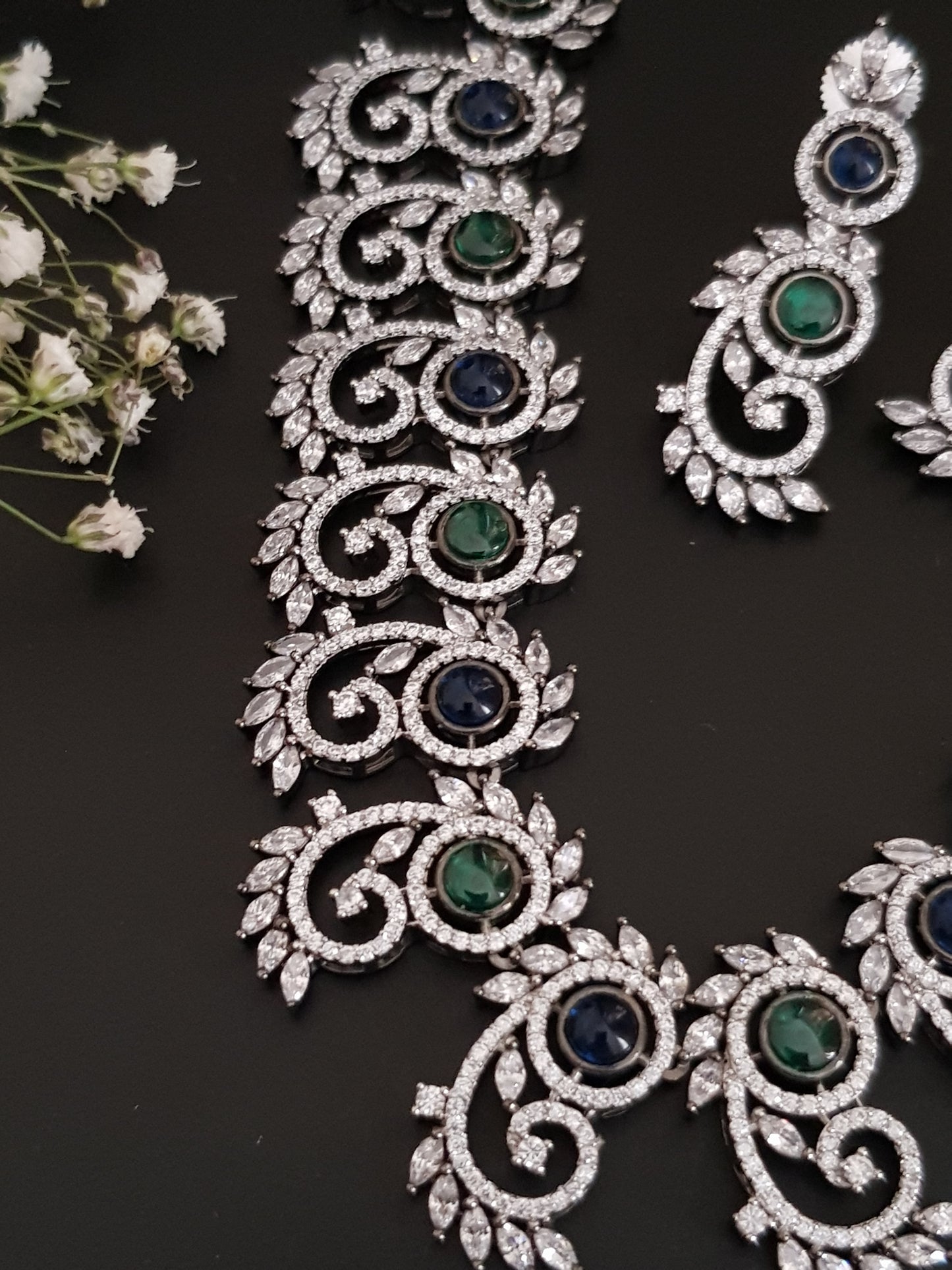 Silver Finish set with elongated C shaped pieces with emerald/sapphire and CZ detailing , matching earrings