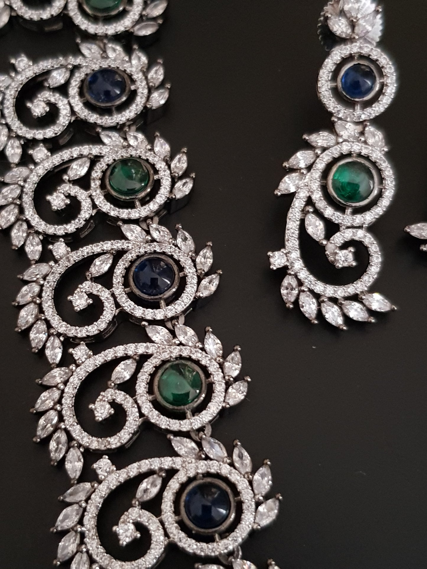 Silver Finish set with elongated C shaped pieces with emerald/sapphire and CZ detailing , matching earrings