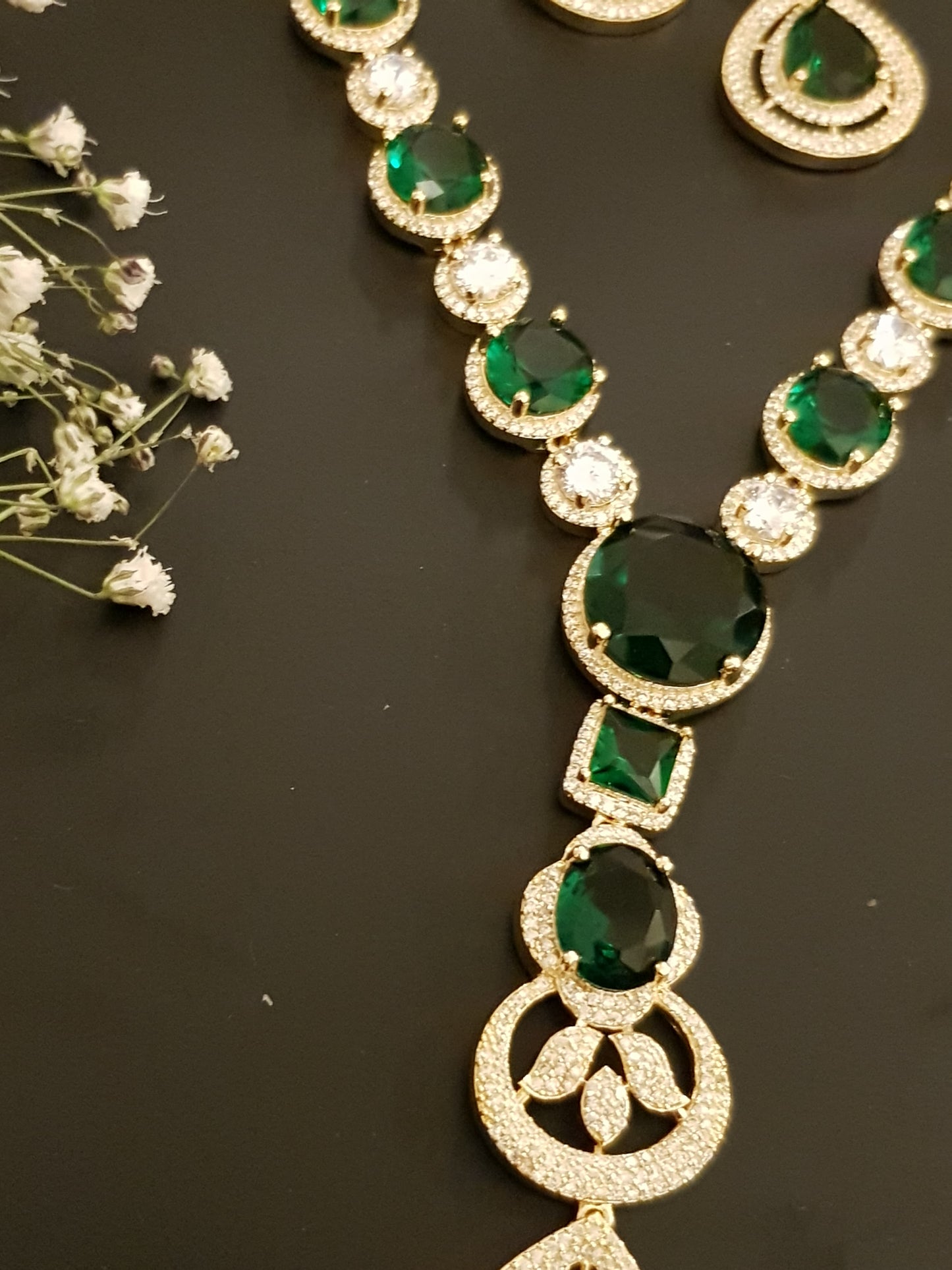 Gold finish set with long necklace in round CZ and emerald pieces, matching earrings