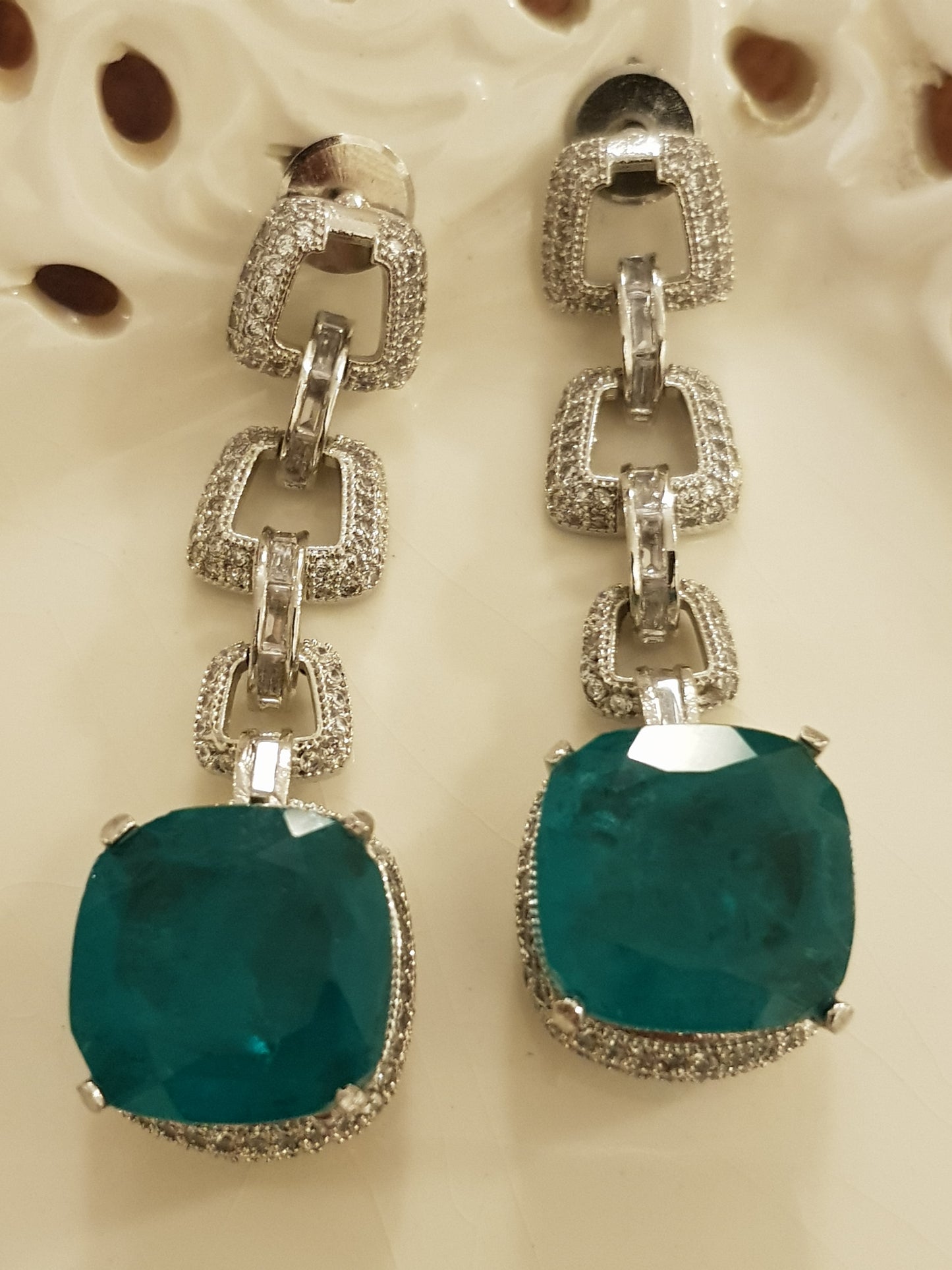 Platinum finish set, necklace in thick chain design with chunky emerald pendant, matching earrings