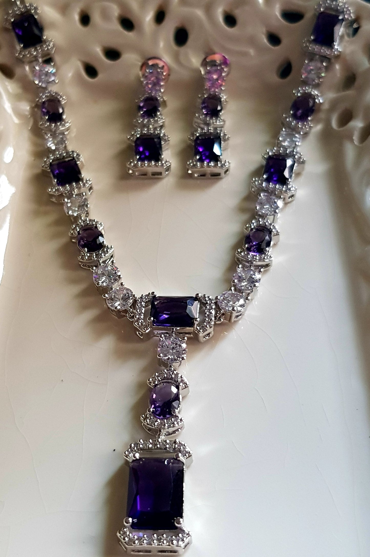 Platinum finish set, amethyst and CZ stones, set in single strand long necklace, matching earrings