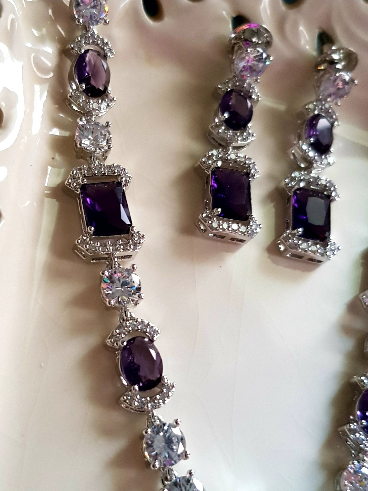 Platinum finish set, amethyst and CZ stones, set in single strand long necklace, matching earrings