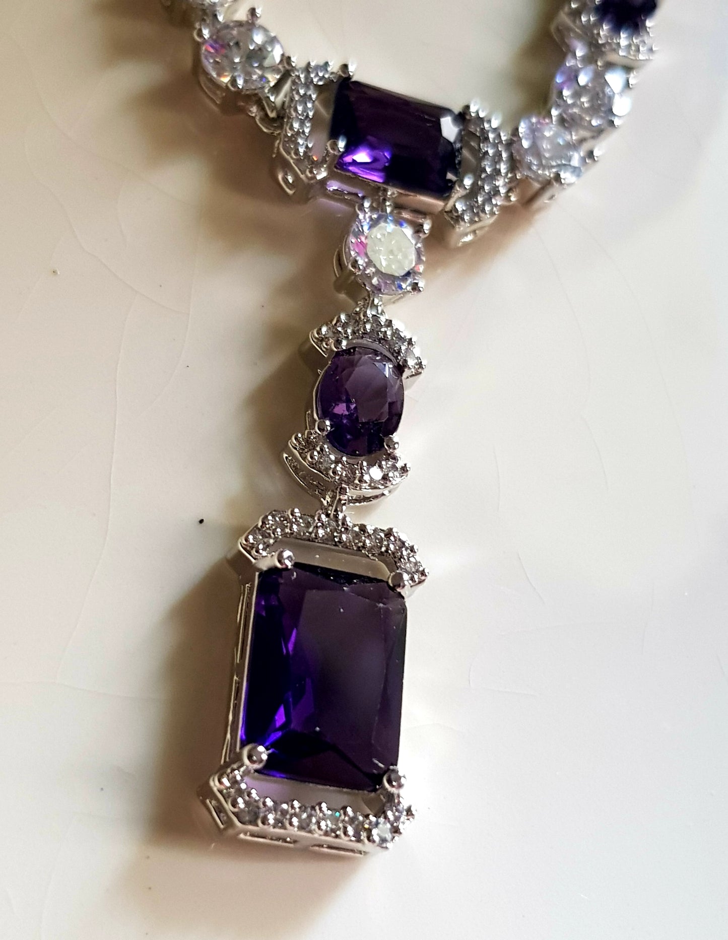 Platinum finish set, amethyst and CZ stones, set in single strand long necklace, matching earrings