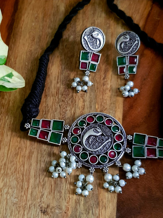 Silver finish choker set with red-green stone inlay, matching earrings