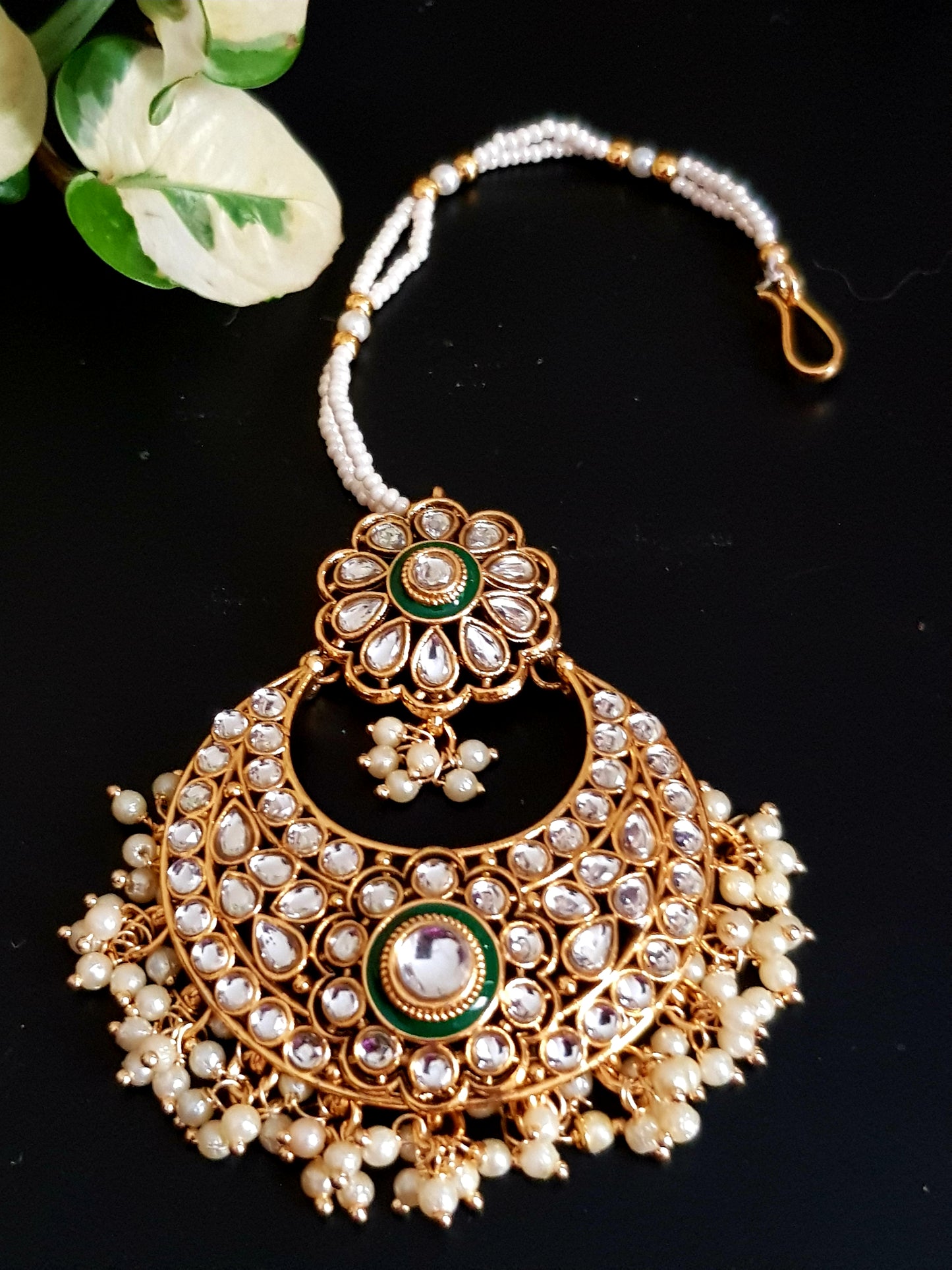 Gold finish big earrings in kundan and pearl with matching maangtika