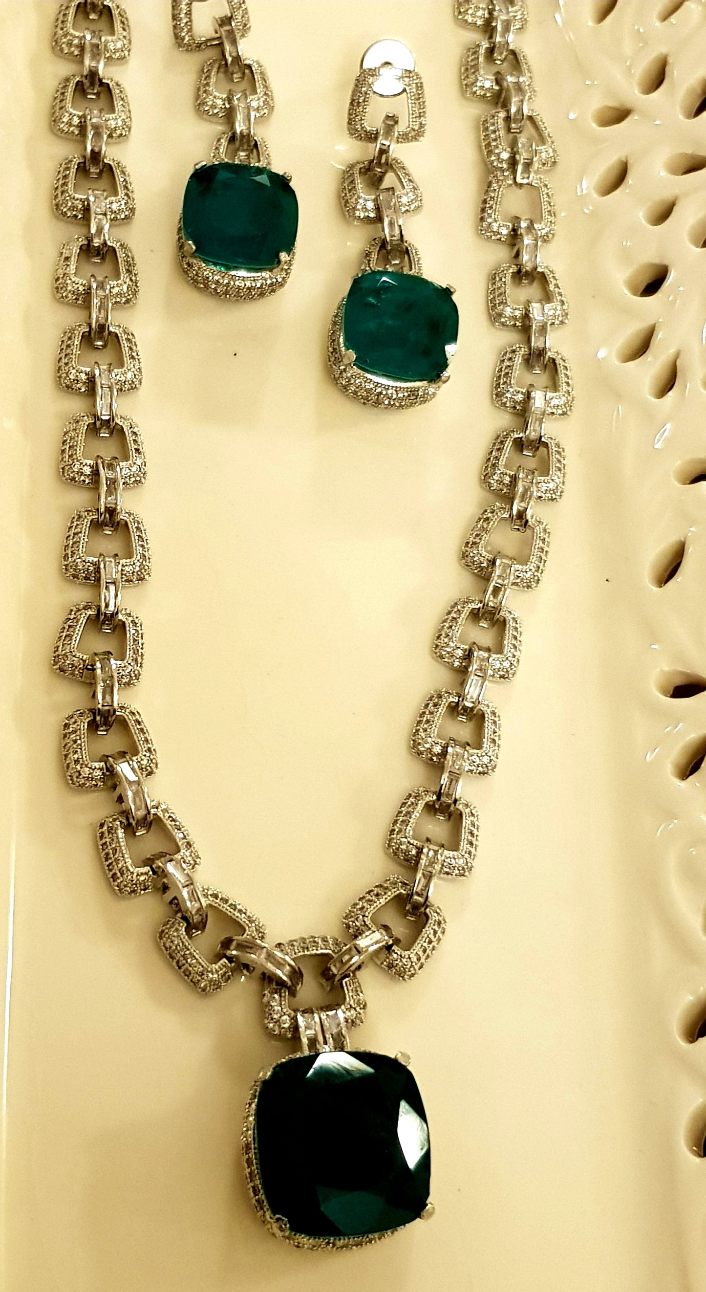 Platinum finish set, necklace in thick chain design with chunky emerald pendant, matching earrings