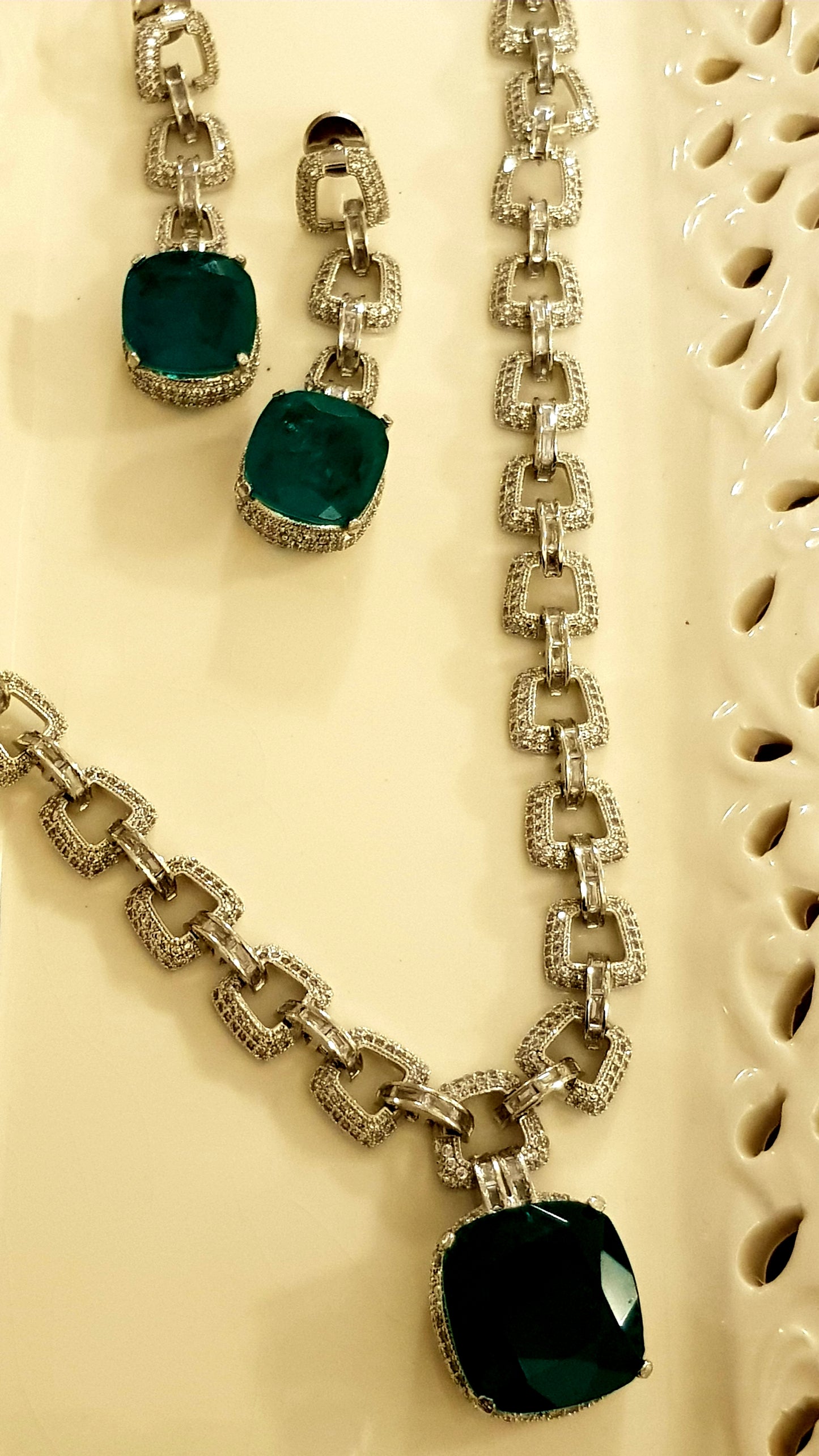 Platinum finish set, necklace in thick chain design with chunky emerald pendant, matching earrings