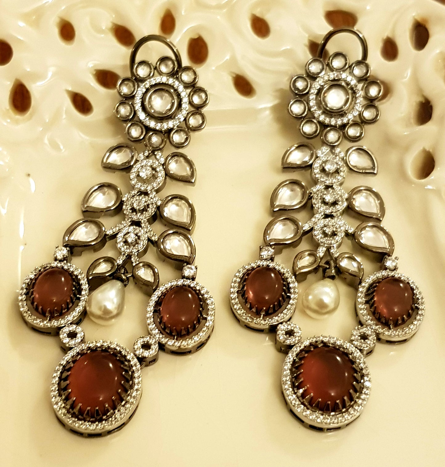 Platinum finish set with plum coloured stone, kundan, pearl and CZ necklace, matching earrings