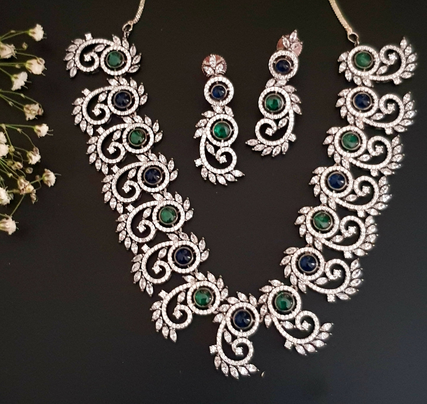 Silver Finish set with elongated C shaped pieces with emerald/sapphire and CZ detailing , matching earrings