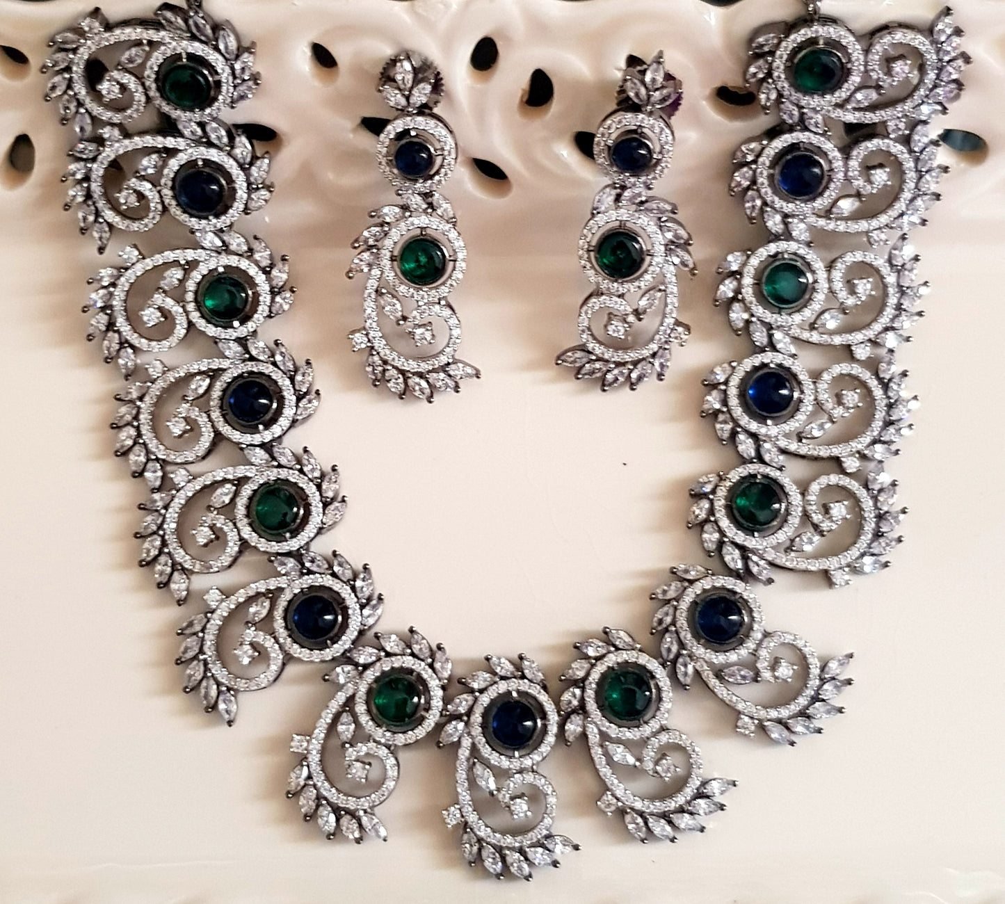 Silver Finish set with elongated C shaped pieces with emerald/sapphire and CZ detailing , matching earrings