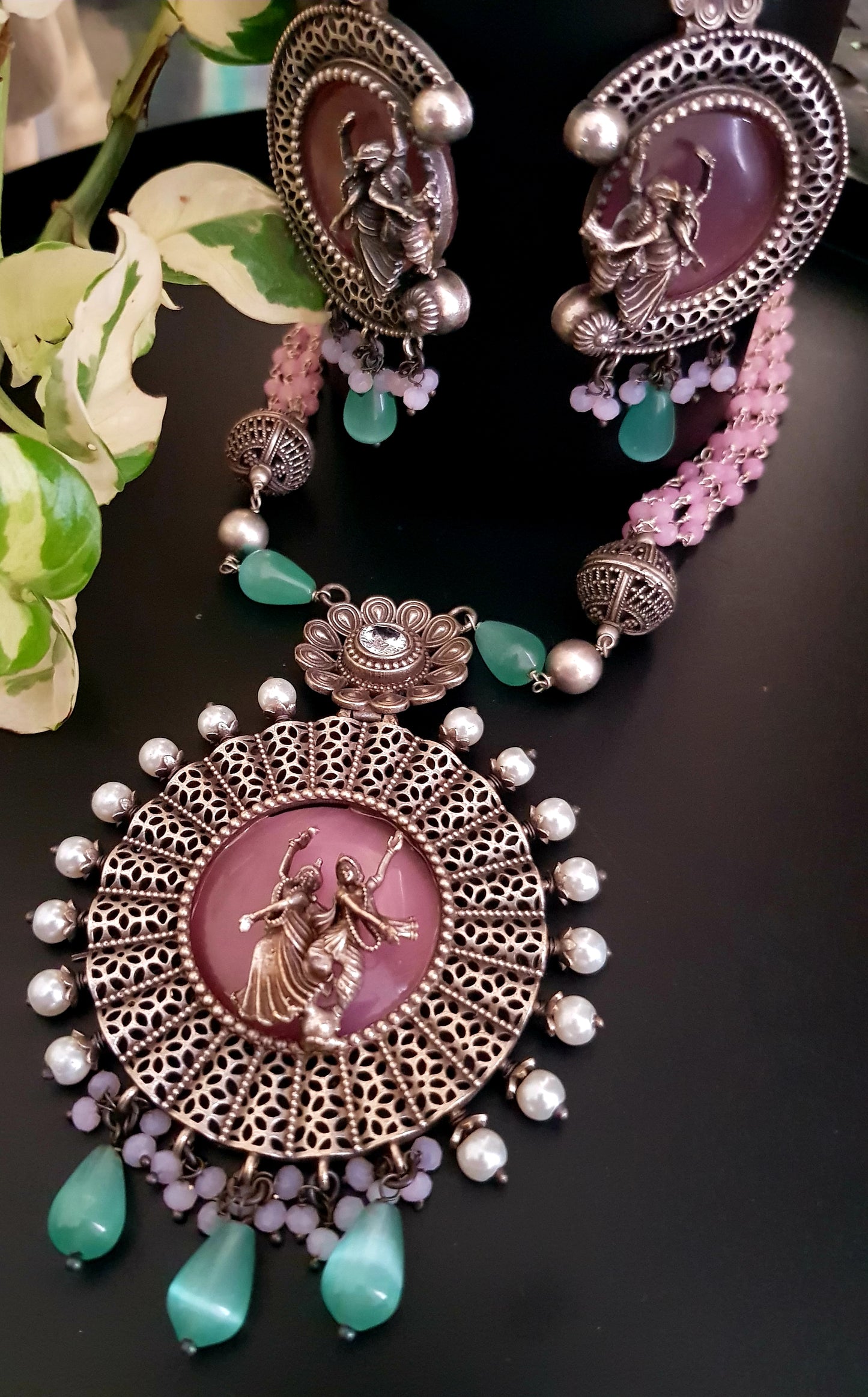 Silver finish set, dancing Radha-Krishna design over pink stone pendant with pearls, matching earrings