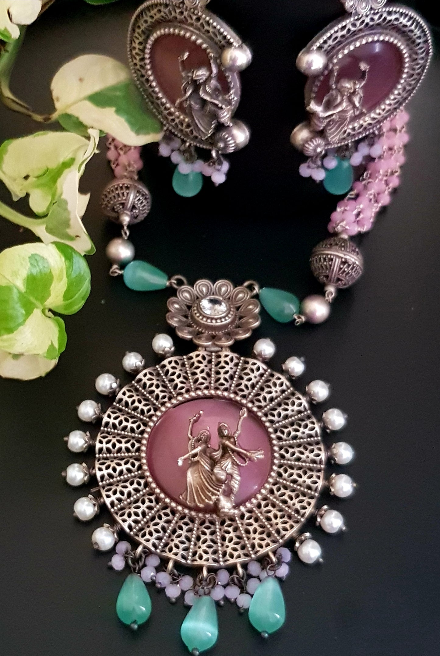 Silver finish set, dancing Radha-Krishna design over pink stone pendant with pearls, matching earrings