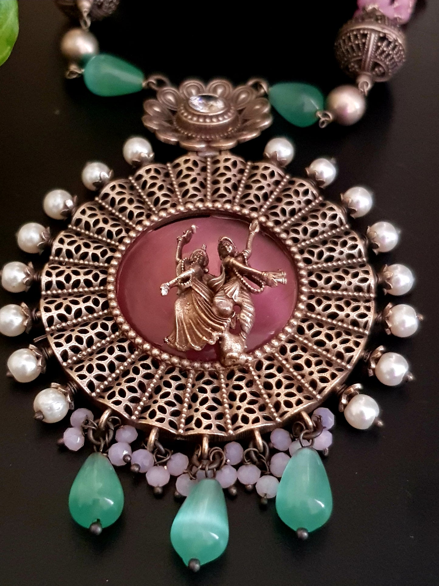 Silver finish set, dancing Radha-Krishna design over pink stone pendant with pearls, matching earrings