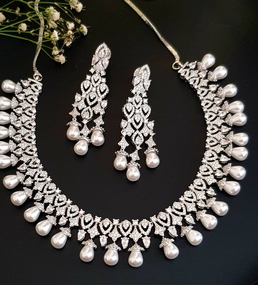 Platinum finish set in CZ and pearl drops , matching earrings