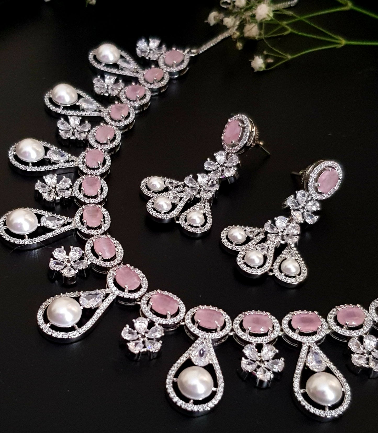 Platinum finish set in pink stone, pearl drops and CZ , matching earrings