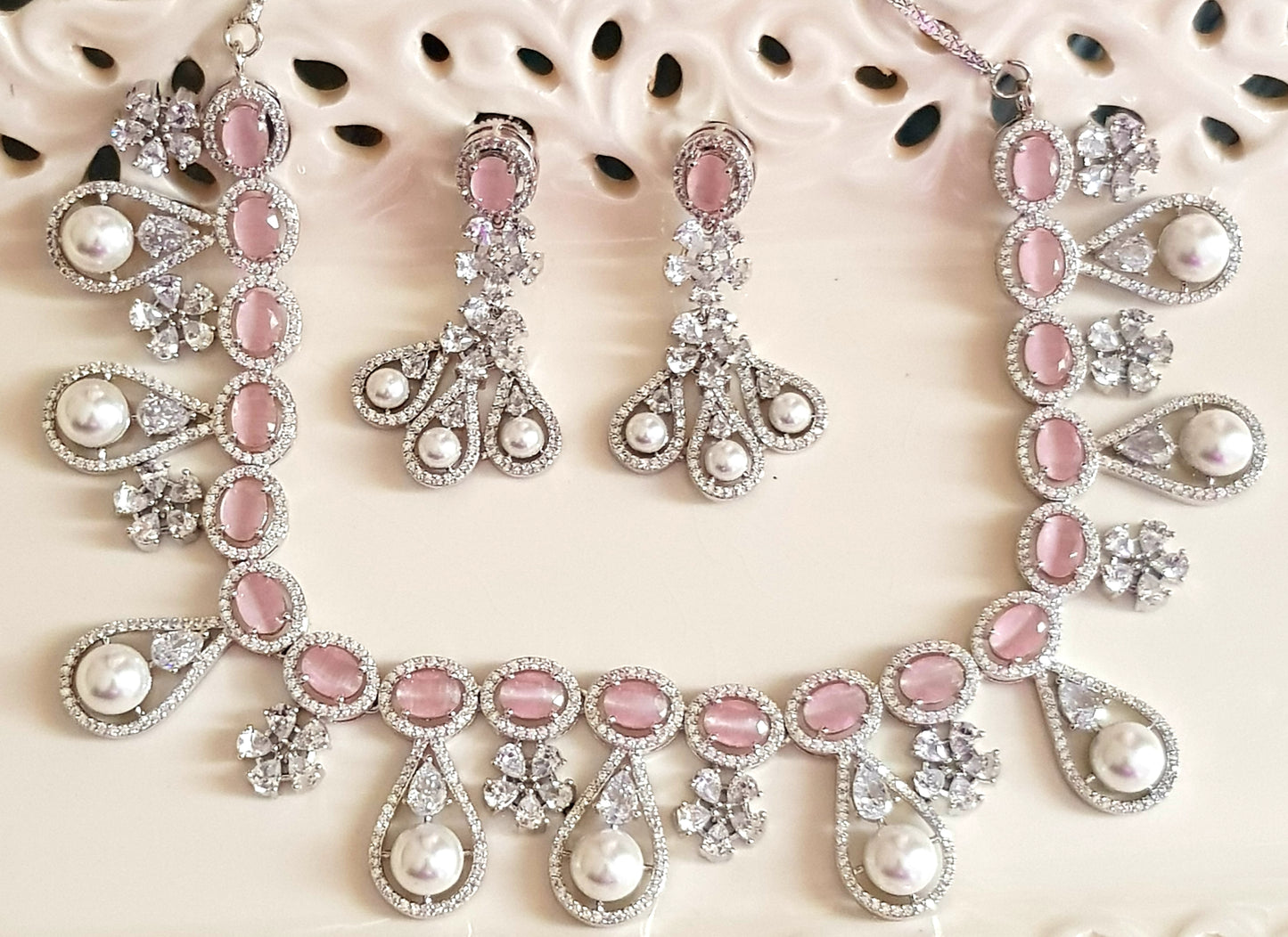 Platinum finish set in pink stone, pearl drops and CZ , matching earrings