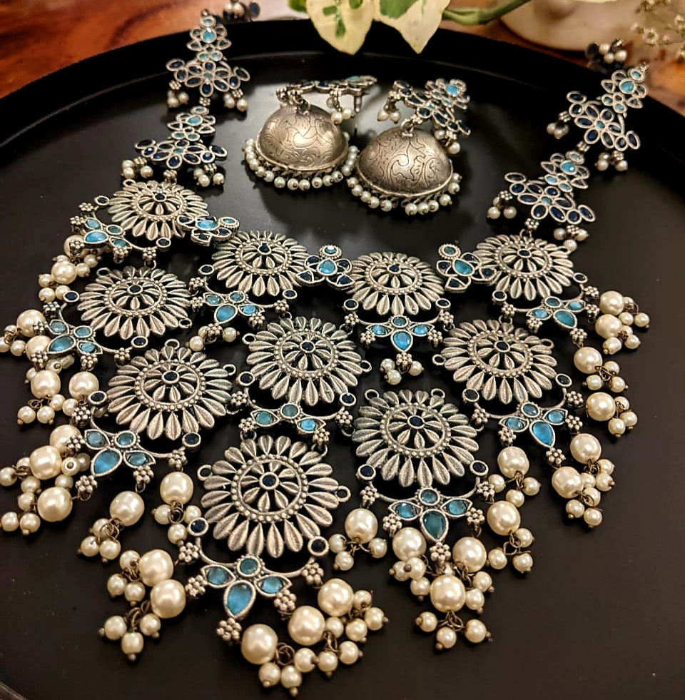 Antique silver finish set, silver flowers big pendant necklace with blue stone and pearl detailing, matching jhumkis (earrings)