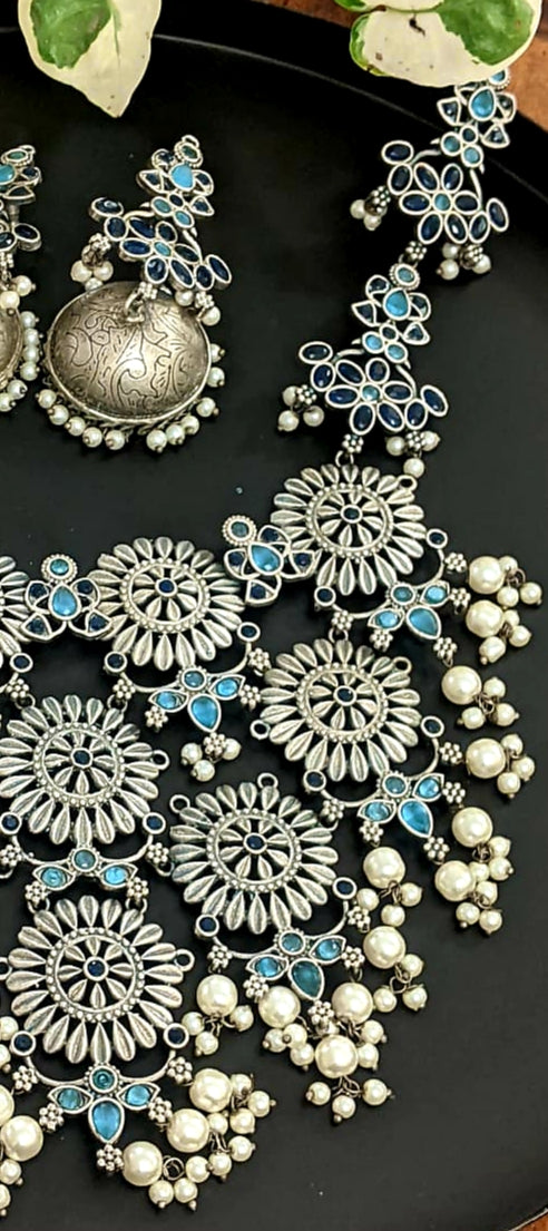 Antique silver finish set, silver flowers big pendant necklace with blue stone and pearl detailing, matching jhumkis (earrings)