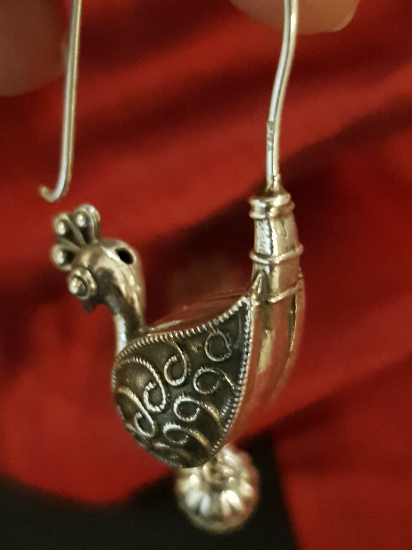 Silver hoop earrings with peacock motif and hanging pearl drops