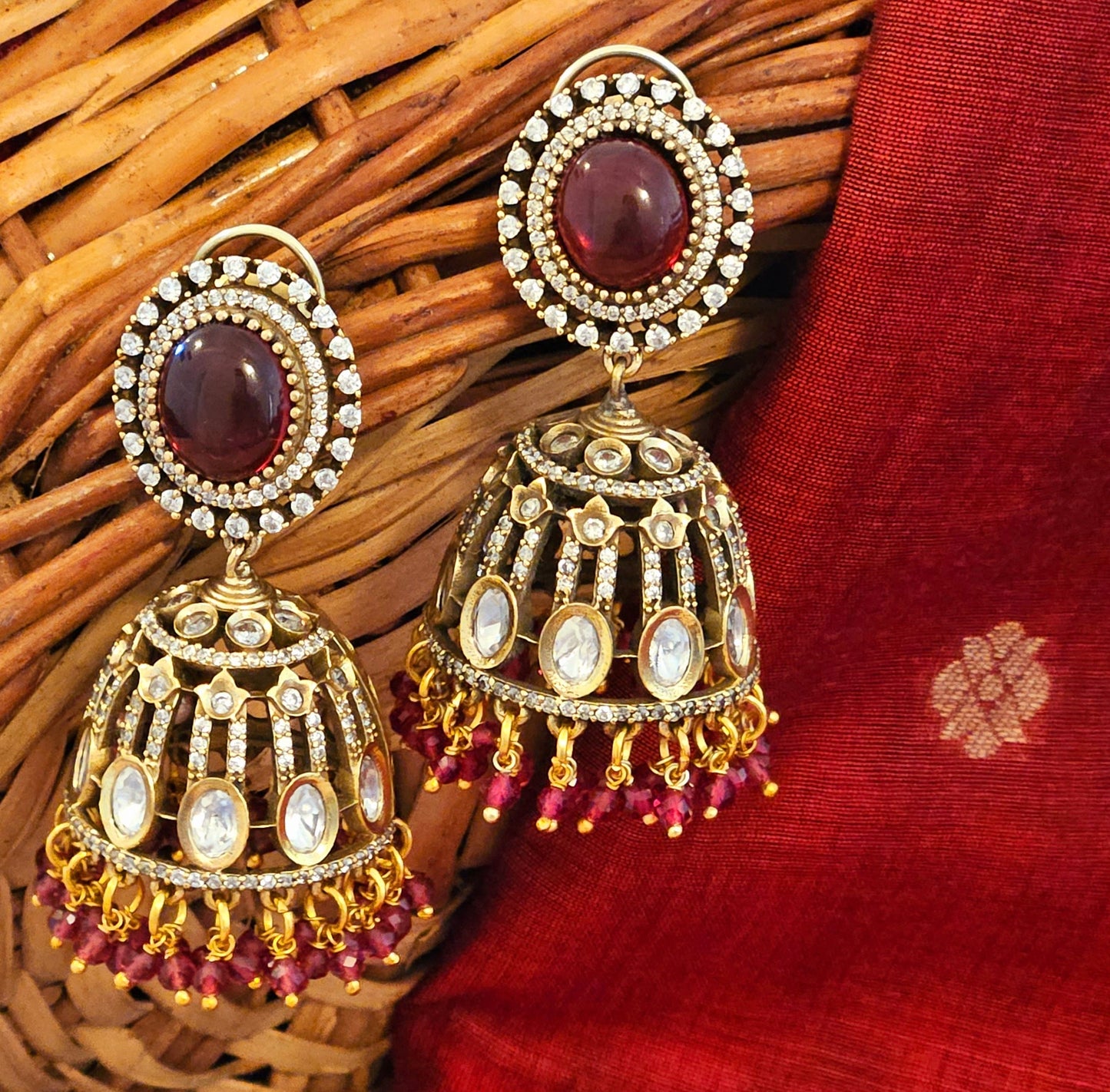 Antique gold finish kundan Jhumka (earrings), oval ruby/emerald stone stud with kundan and clear stone detailing on dome