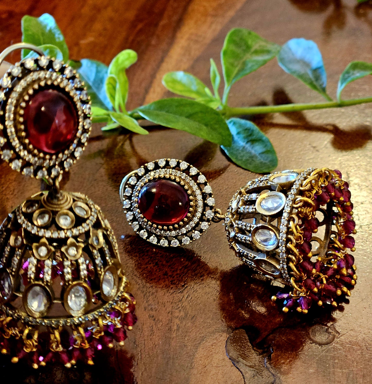 Antique gold finish kundan Jhumka (earrings), oval ruby/emerald stone stud with kundan and clear stone detailing on dome