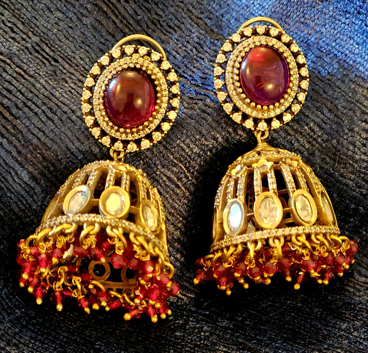 Antique gold finish kundan Jhumka (earrings), oval ruby/emerald stone stud with kundan and clear stone detailing on dome