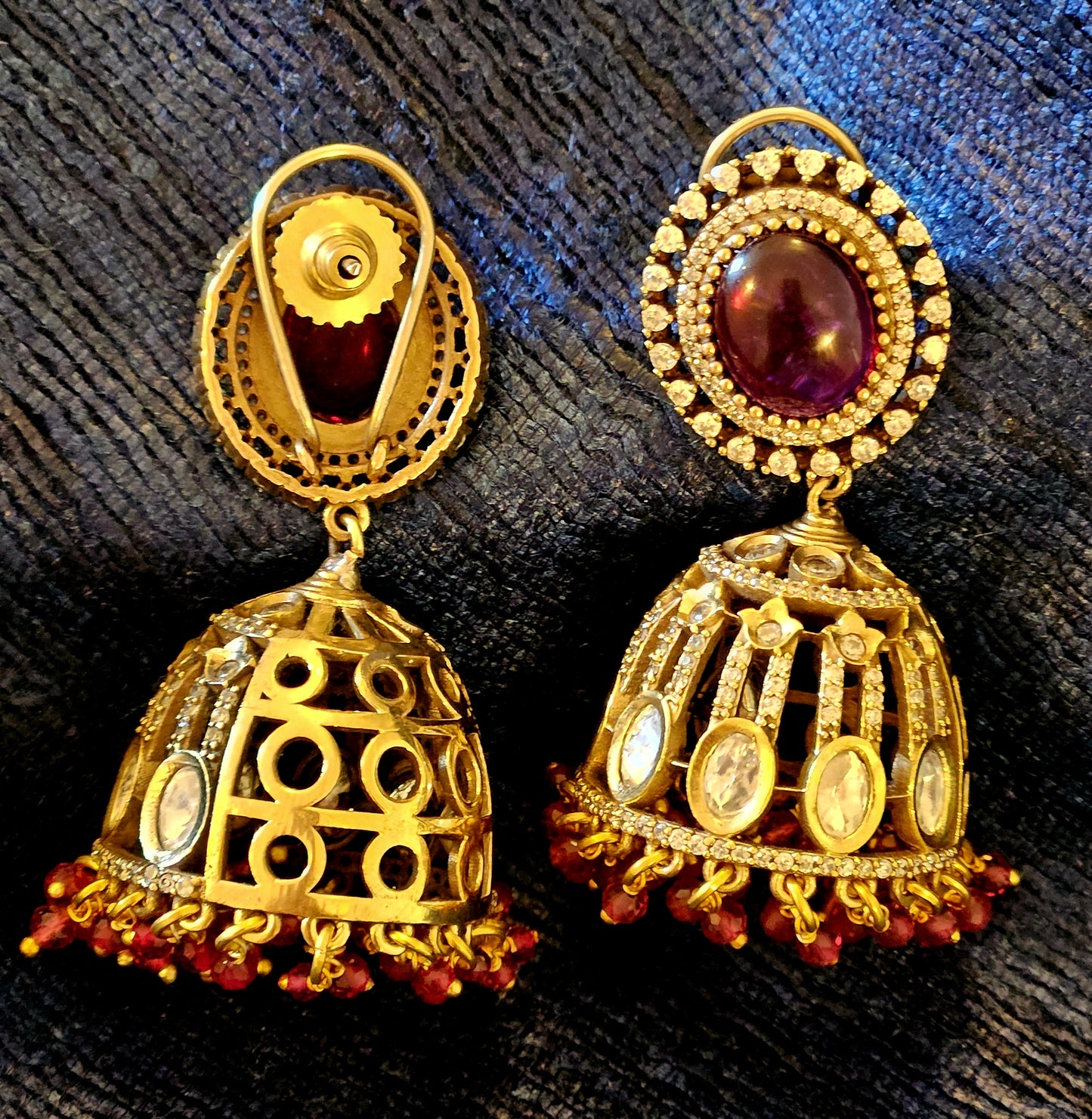 Antique gold finish kundan Jhumka (earrings), oval ruby/emerald stone stud with kundan and clear stone detailing on dome