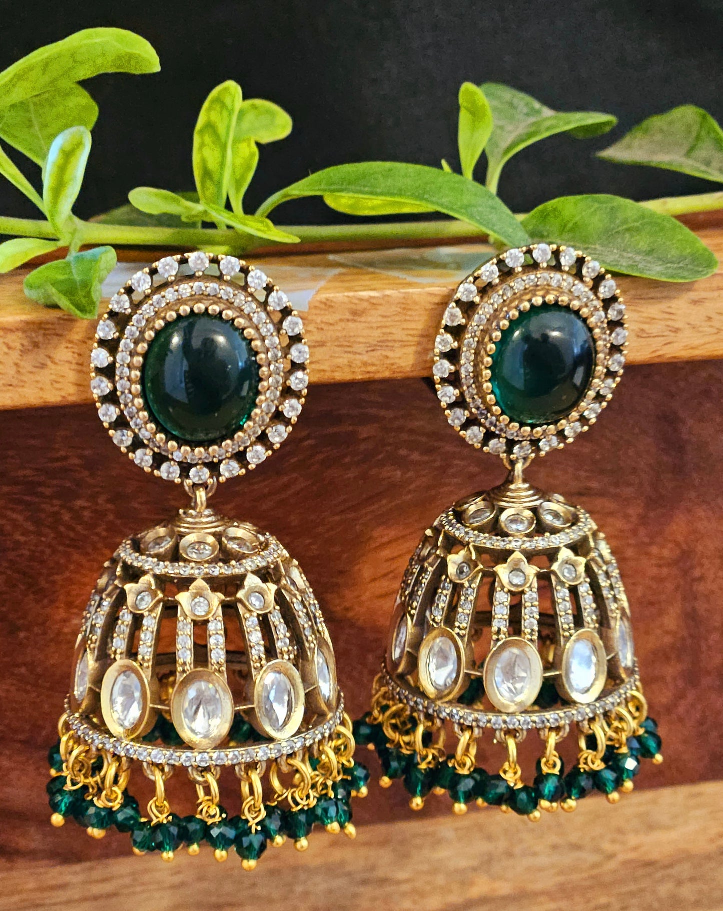 Antique gold finish kundan Jhumka (earrings), oval ruby/emerald stone stud with kundan and clear stone detailing on dome