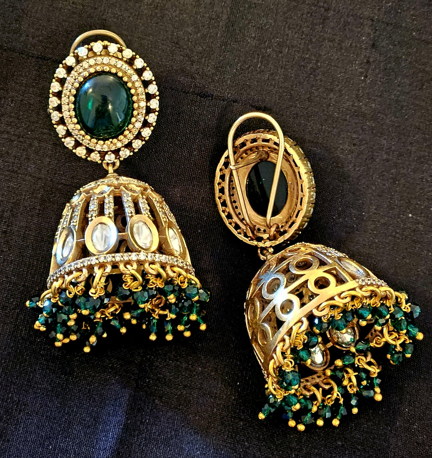 Antique gold finish kundan Jhumka (earrings), oval ruby/emerald stone stud with kundan and clear stone detailing on dome