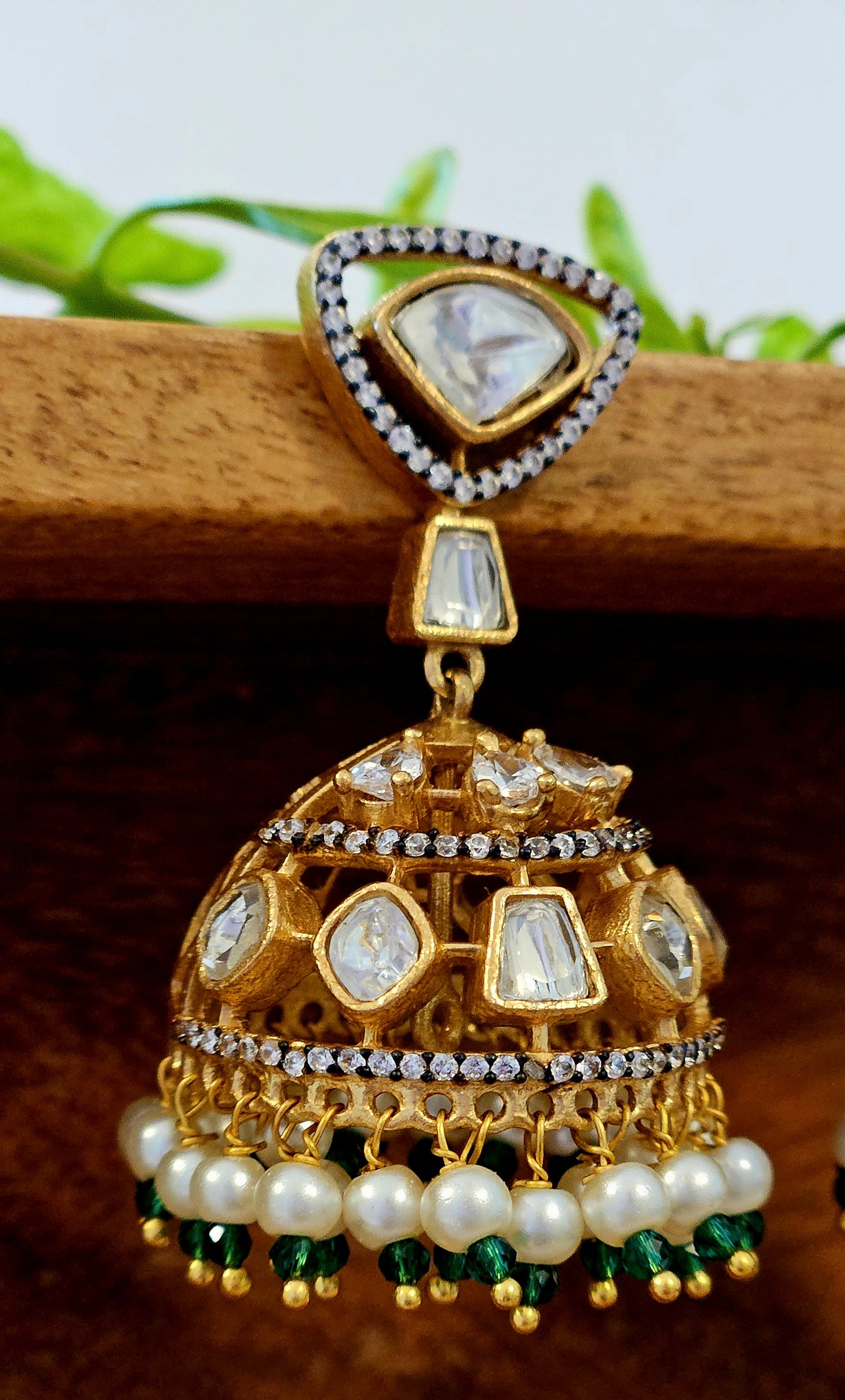 Antique gold finish kundan jhumka (earrings) with CZ and pearl hangings at the bottom of dome, kundan stud