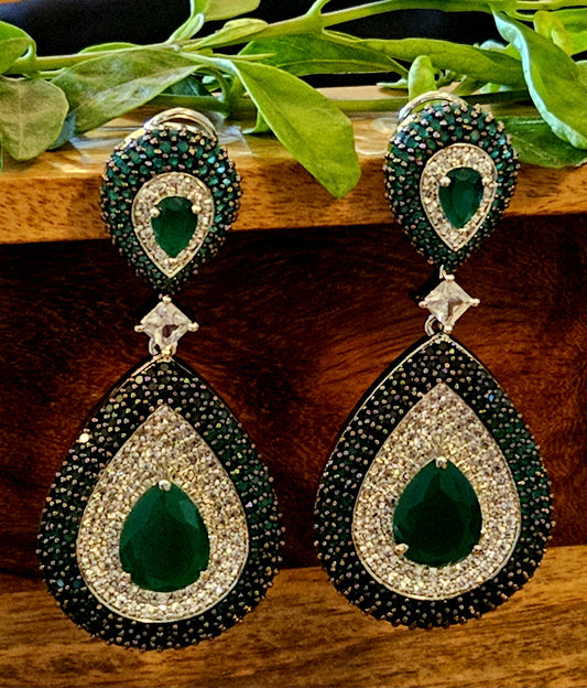 Platinum finish danglers (earrings), big teardrop shape with emerald/ruby and clear stone piece hanging under matching stud