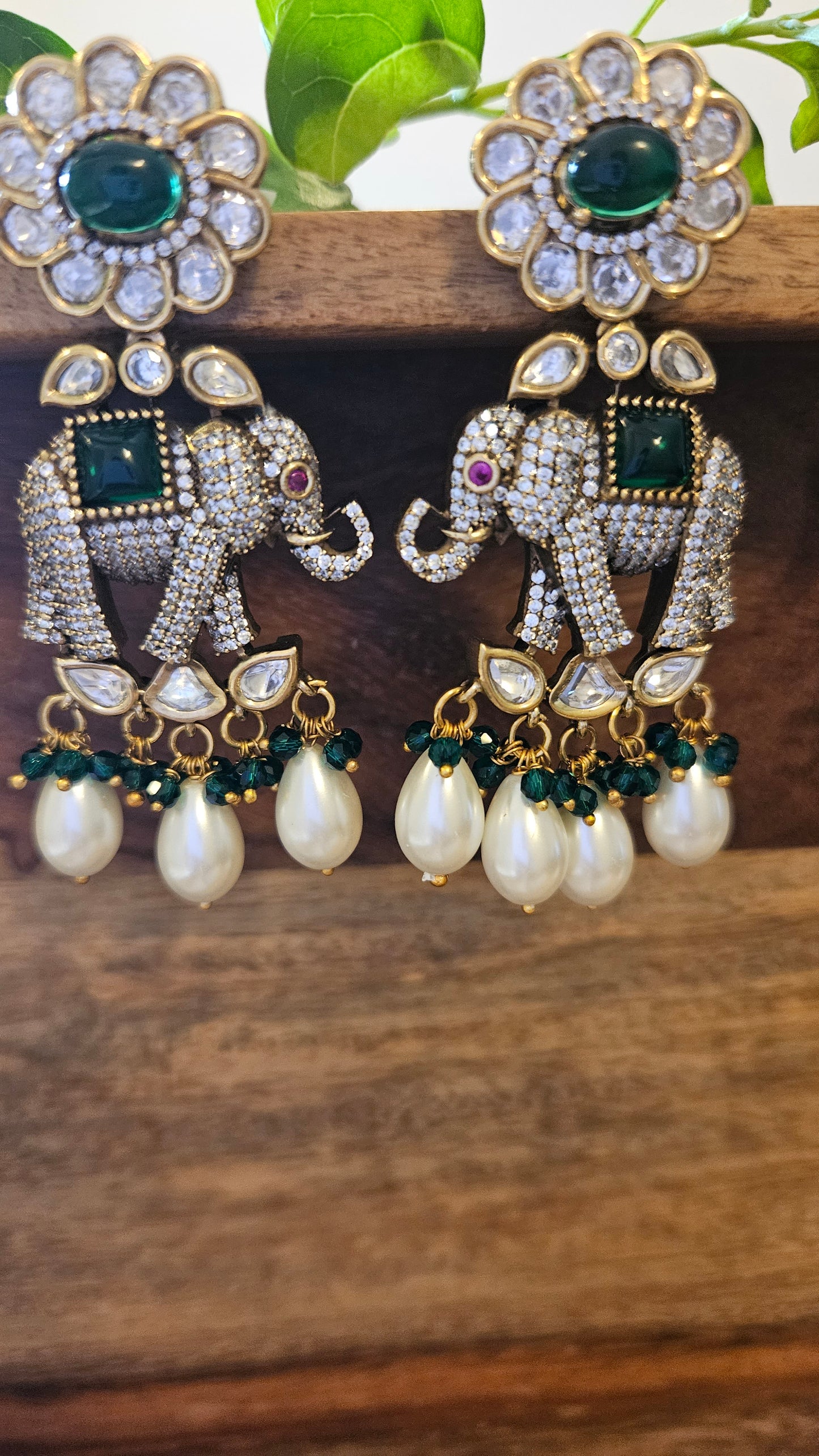 Elephant motif earrings in CZ, kundan, emerald detailing and big pearl hangings