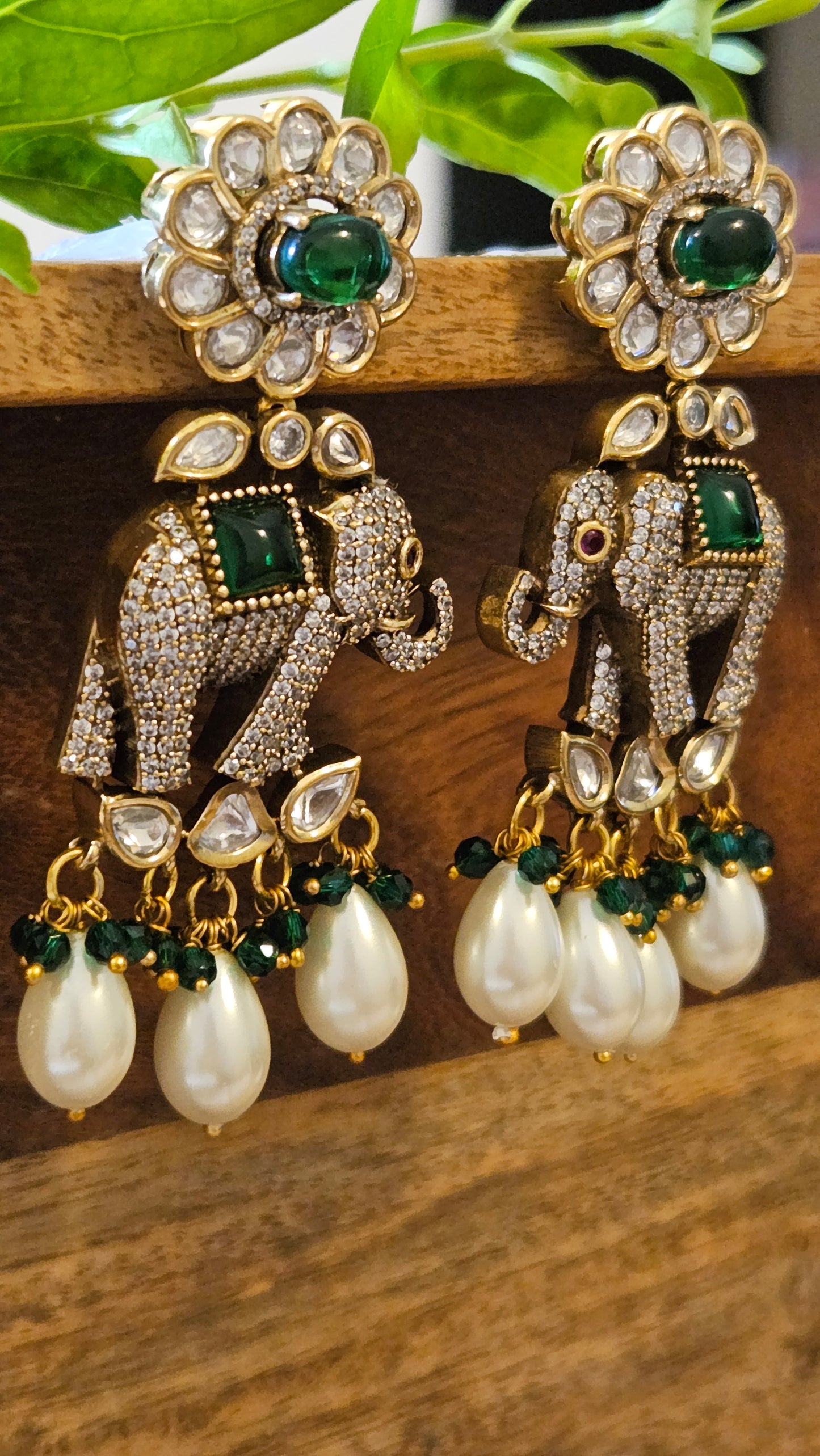 Elephant motif earrings in CZ, kundan, emerald detailing and big pearl hangings