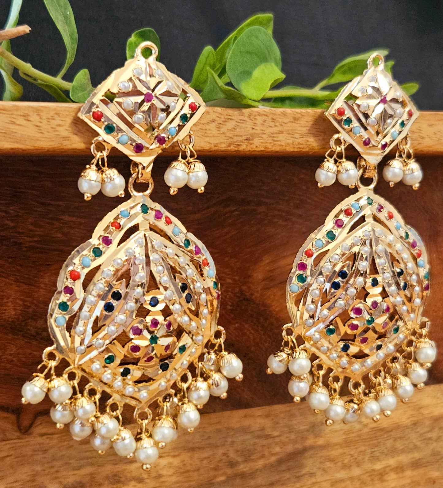 Gold finish jadau earrings with navratan stone inlay and pearl finishing