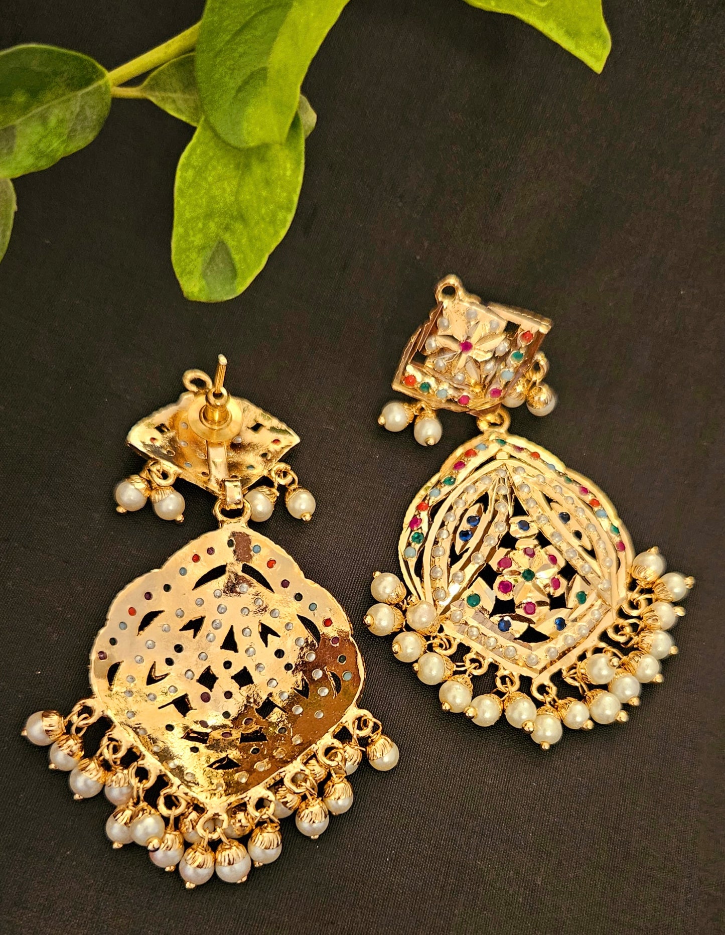 Gold finish jadau earrings with navratan stone inlay and pearl finishing