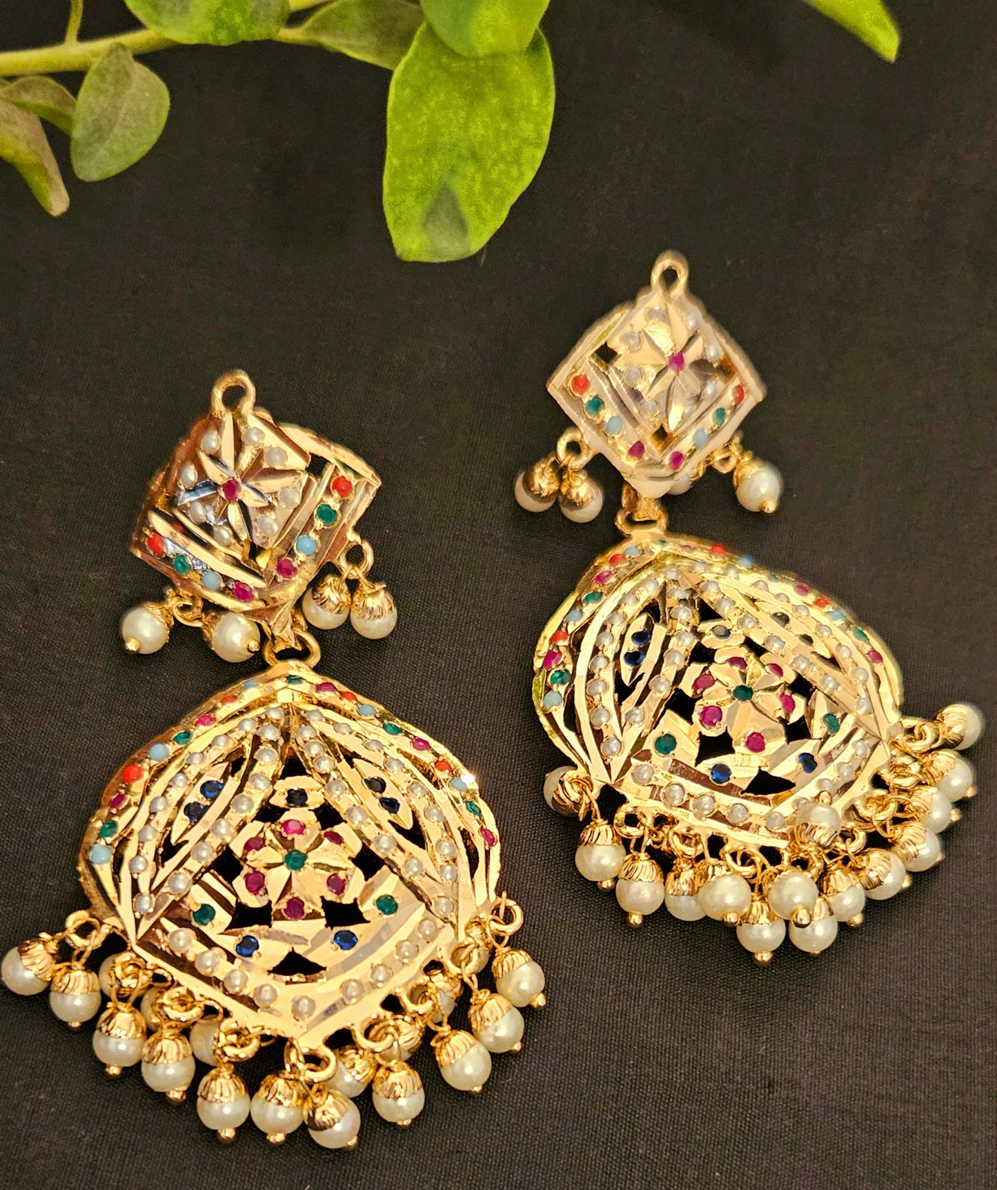 Gold finish jadau earrings with navratan stone inlay and pearl finishing