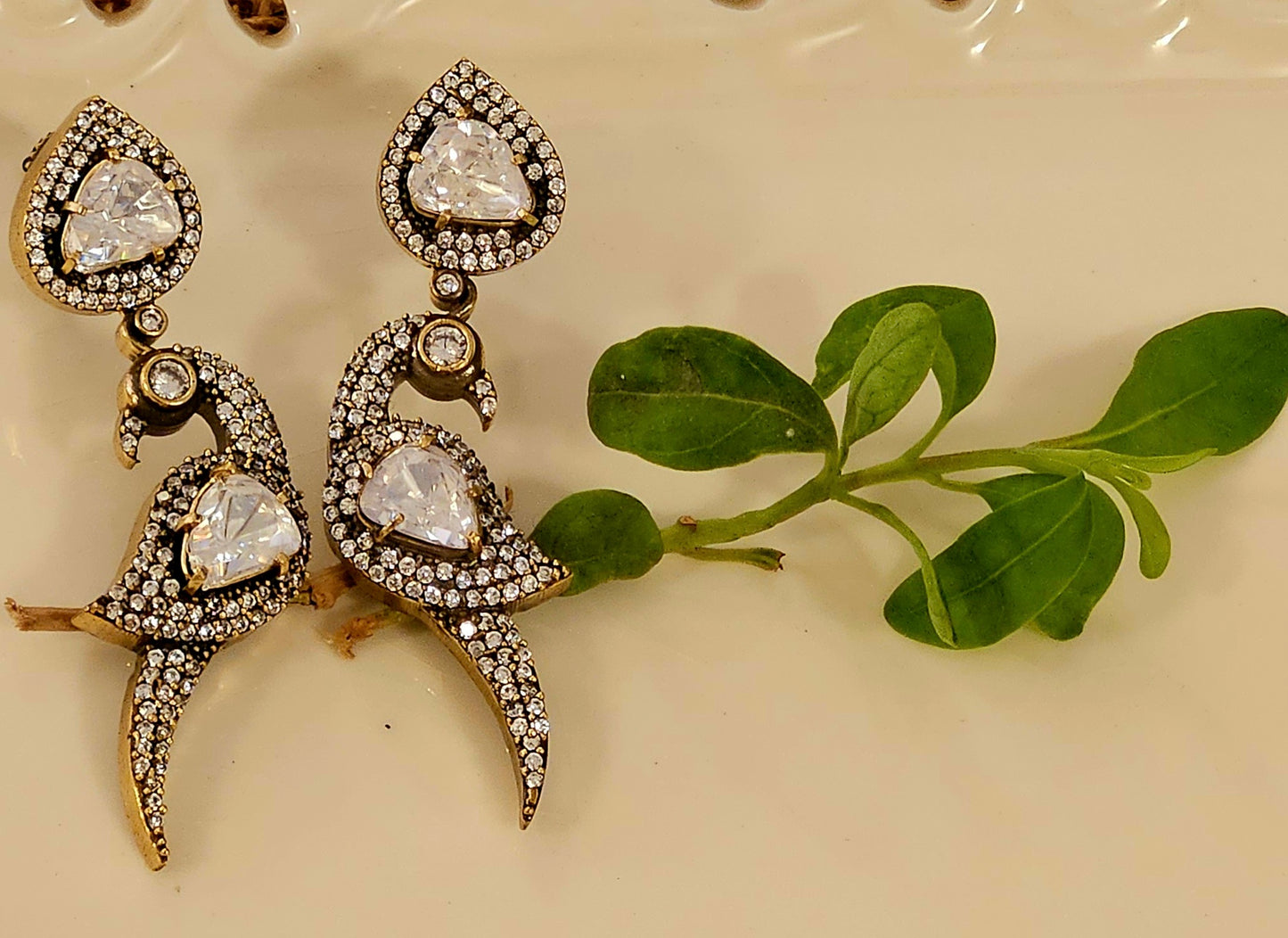 Antique gold finish earrings, parrot design with kundan and CZ detailing