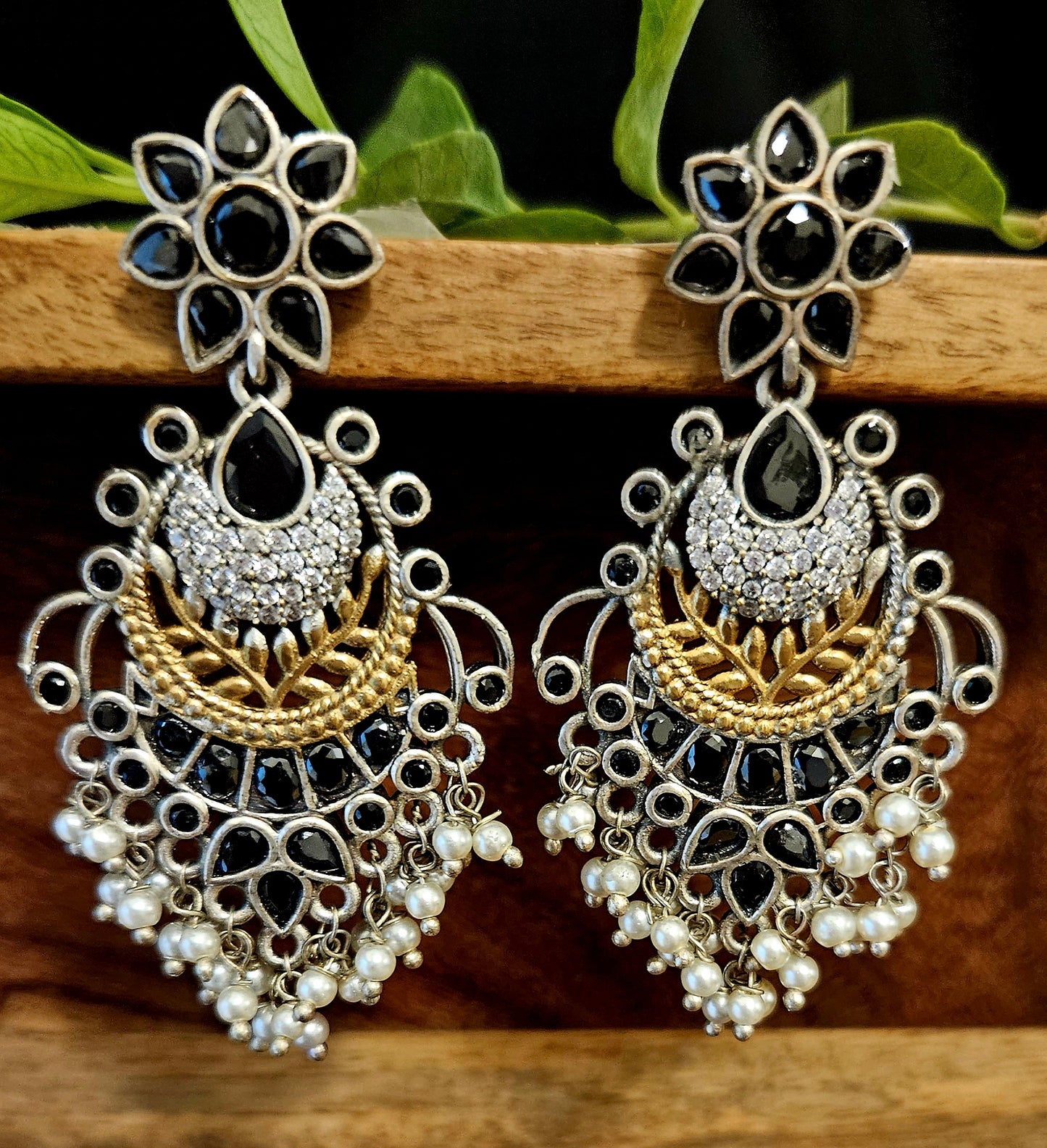 Earrings in dual tone with pale pink/black coloured stone and pearls