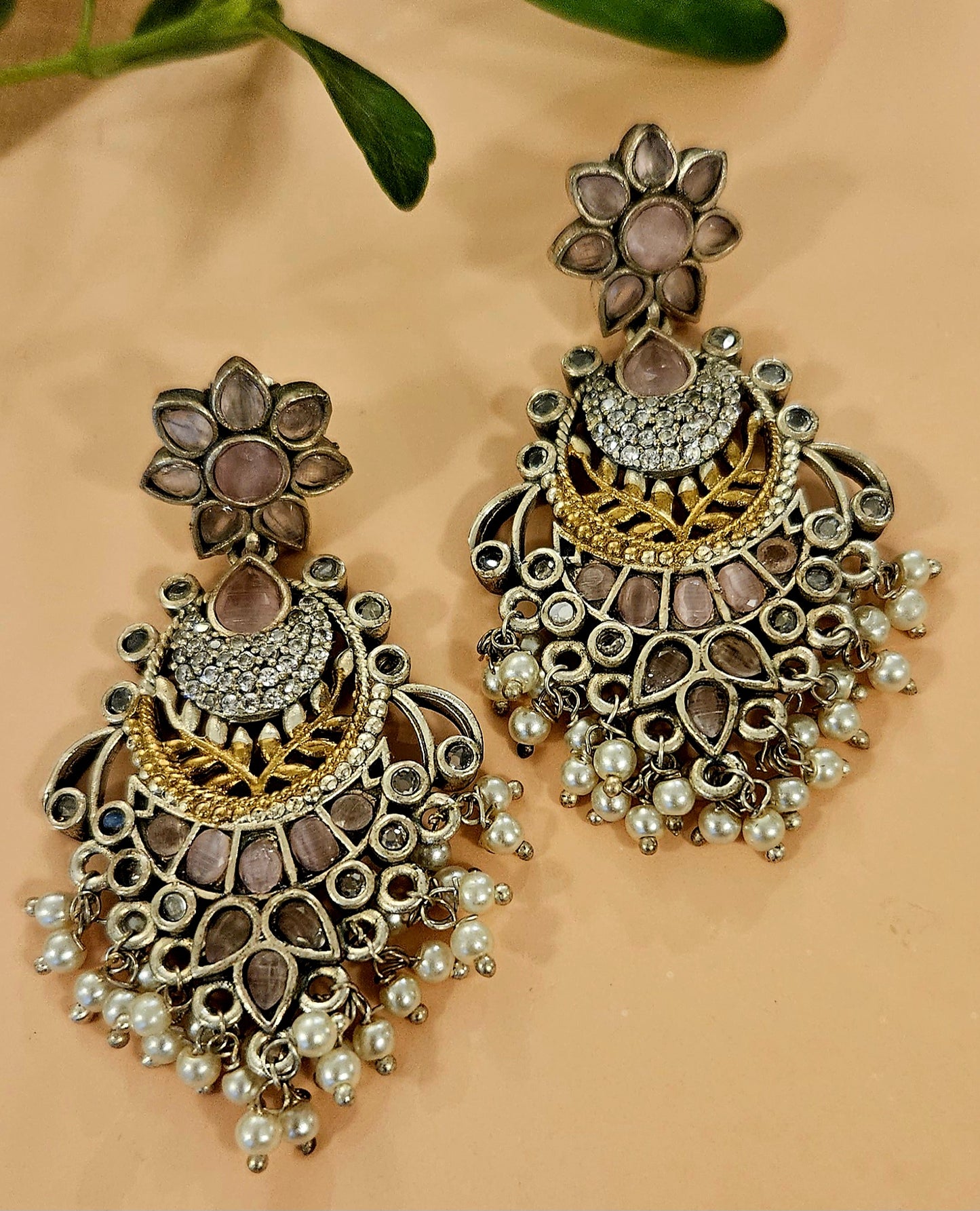 Earrings in dual tone with pale pink/black coloured stone and pearls