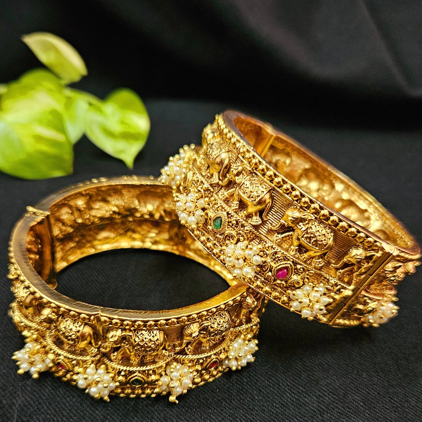 Gold finish broad kara (bangle) with marching elephants and pearl bead cluster (2 pcs)