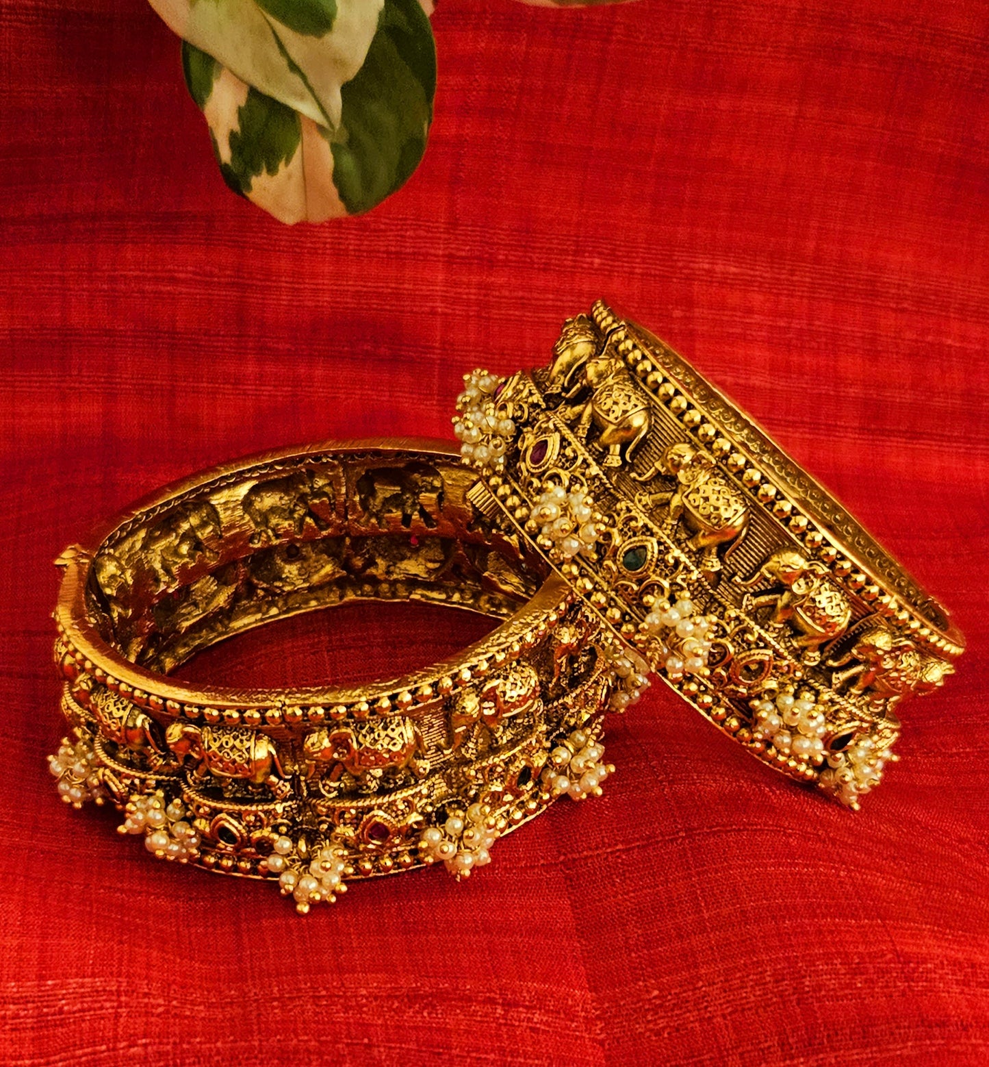 Gold finish broad kara (bangle) with marching elephants and pearl bead cluster (2 pcs)